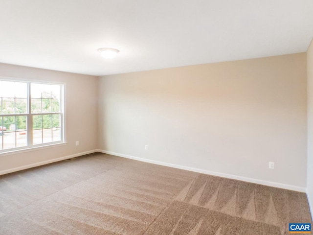 empty room featuring light carpet