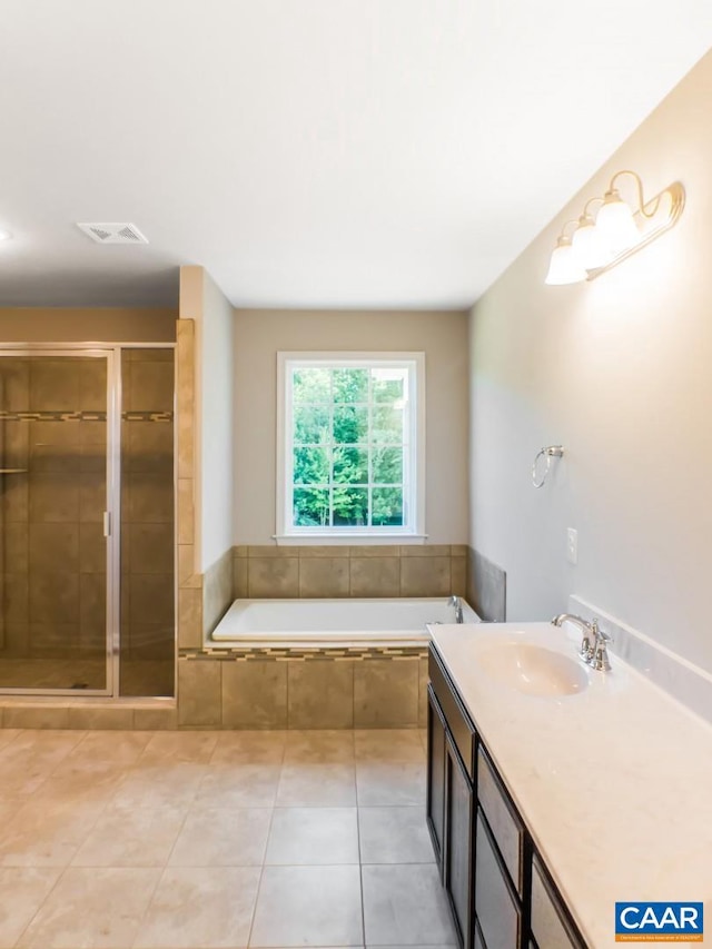 bathroom featuring tile floors, vanity, and plus walk in shower