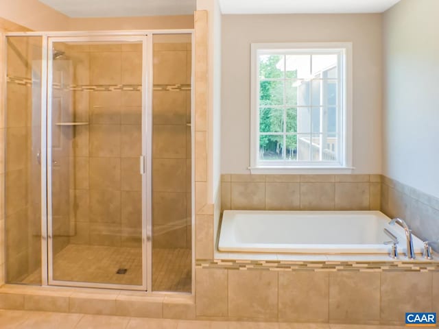 bathroom with independent shower and bath and tile flooring