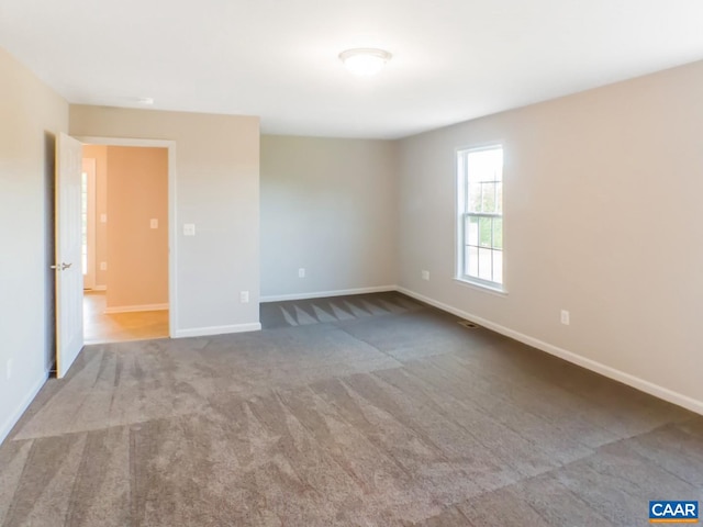 unfurnished room with light carpet