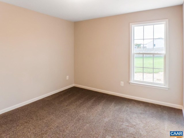 carpeted spare room featuring plenty of natural light