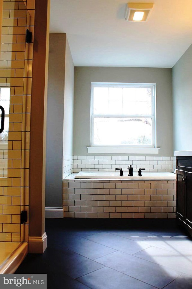 bathroom featuring separate shower and tub, tile flooring, and vanity