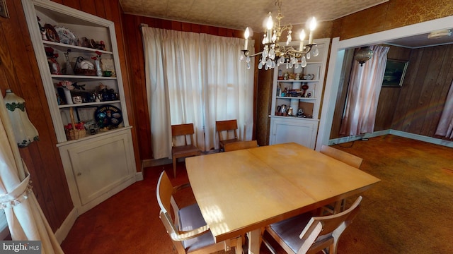 carpeted dining space featuring wooden walls, a notable chandelier, and built in shelves