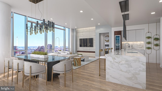 dining space with hardwood / wood-style floors and sink