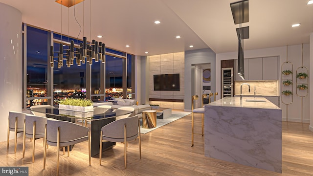 dining space featuring sink and light hardwood / wood-style flooring