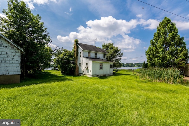 view of yard with a water view and an outdoor structure