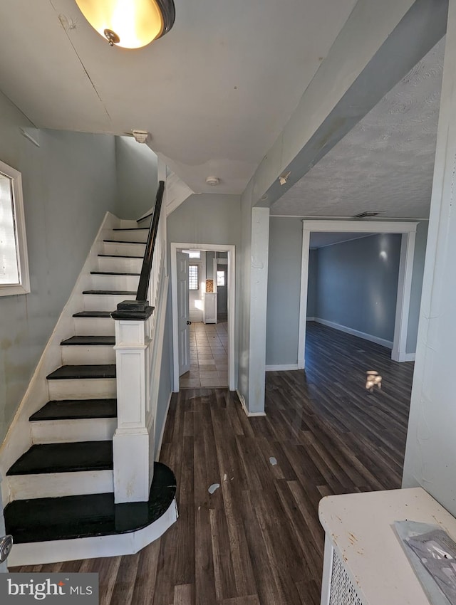 stairway featuring dark hardwood / wood-style floors