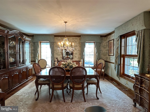 dining area featuring dark hardwood / wood-style flooring, a chandelier, and a healthy amount of sunlight