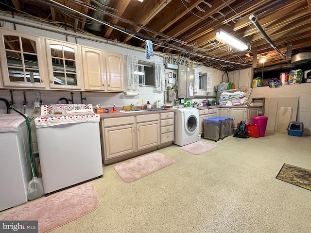 clothes washing area featuring cabinets, washer / dryer, and sink