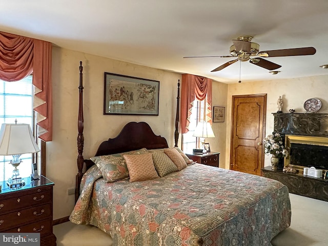 bedroom featuring ceiling fan and carpet