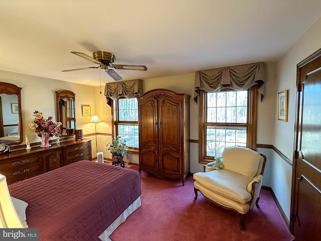 bedroom featuring ceiling fan and dark colored carpet