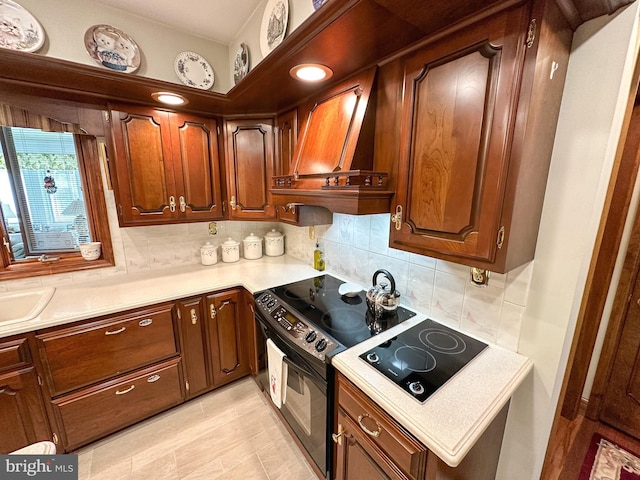 kitchen featuring custom range hood, backsplash, black appliances, and sink