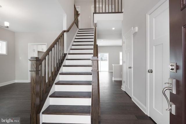 staircase with hardwood / wood-style floors and a wealth of natural light