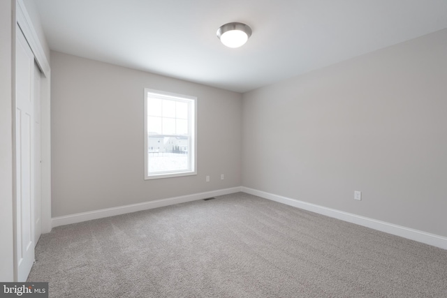 unfurnished bedroom featuring a closet and carpet flooring