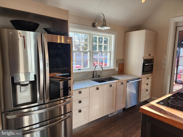 kitchen featuring dark hardwood / wood-style floors, black appliances, sink, white cabinets, and light stone counters