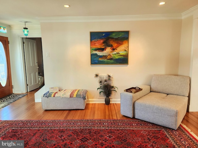 living room featuring light hardwood / wood-style floors and ornamental molding