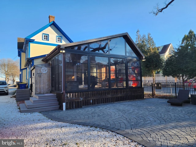 view of front of house featuring a sunroom