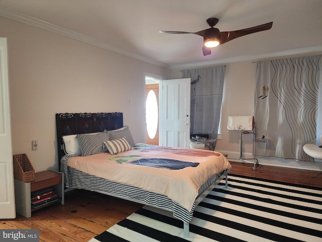 bedroom with dark hardwood / wood-style flooring, ceiling fan, and ornamental molding