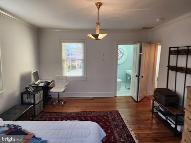 bedroom featuring crown molding, dark hardwood / wood-style floors, and ensuite bath