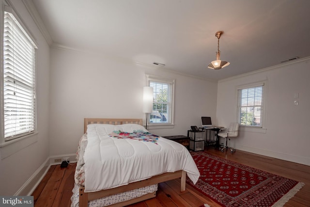 bedroom featuring dark hardwood / wood-style flooring and crown molding