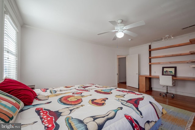 bedroom featuring crown molding, ceiling fan, and hardwood / wood-style floors