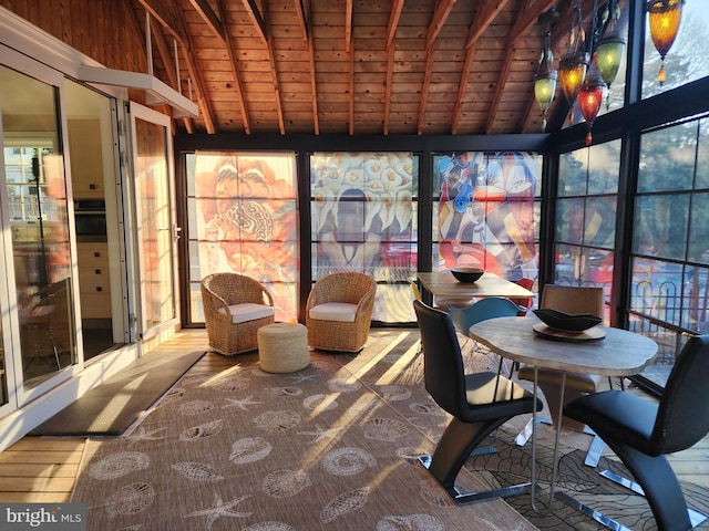 unfurnished sunroom with vaulted ceiling with beams and wood ceiling