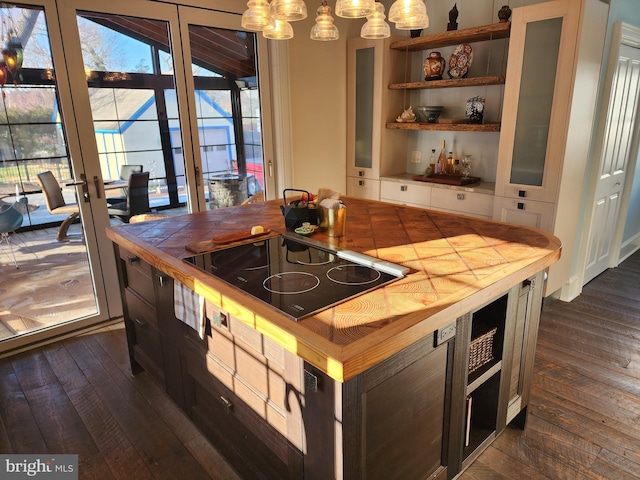 kitchen with black electric cooktop, a healthy amount of sunlight, tile counters, and dark hardwood / wood-style flooring