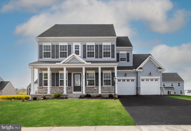 view of front facade featuring a porch, a garage, and a front yard