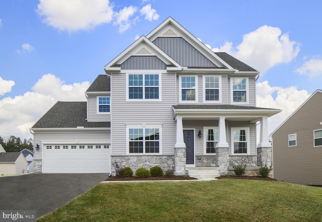 craftsman-style house with a garage, a front yard, and covered porch