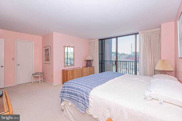 bedroom with light colored carpet and access to outside