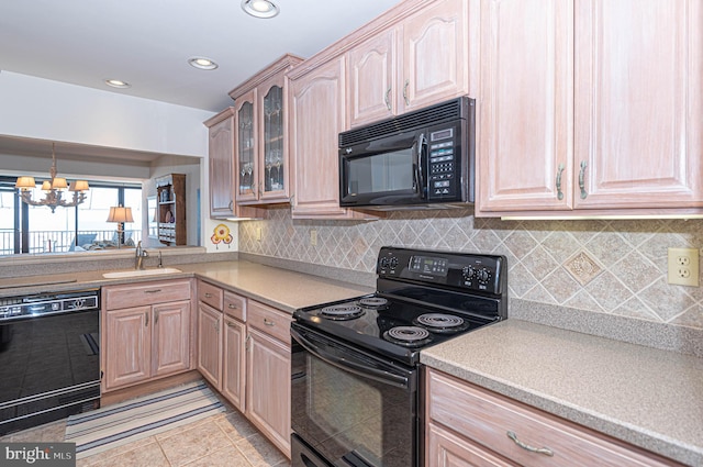 kitchen with an inviting chandelier, tasteful backsplash, light tile floors, sink, and black appliances