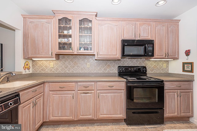 kitchen featuring black appliances, sink, light tile floors, light brown cabinetry, and tasteful backsplash