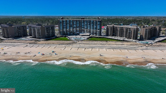 birds eye view of property with a beach view and a water view