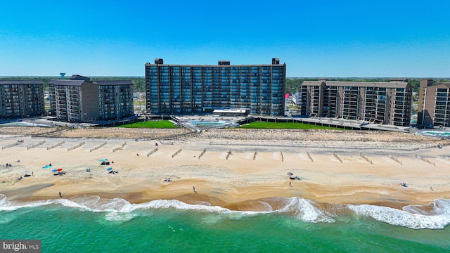 drone / aerial view featuring a water view and a view of the beach