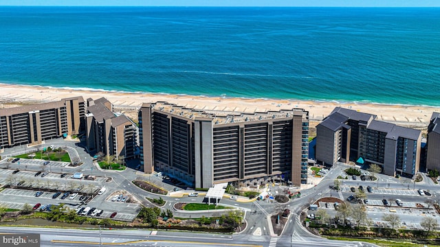 bird's eye view with a water view and a view of the beach