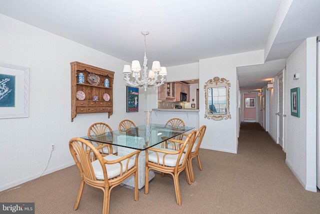 carpeted dining space with a notable chandelier