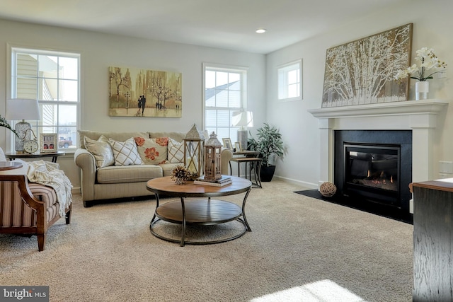 living room with carpet, a fireplace with flush hearth, baseboards, and recessed lighting