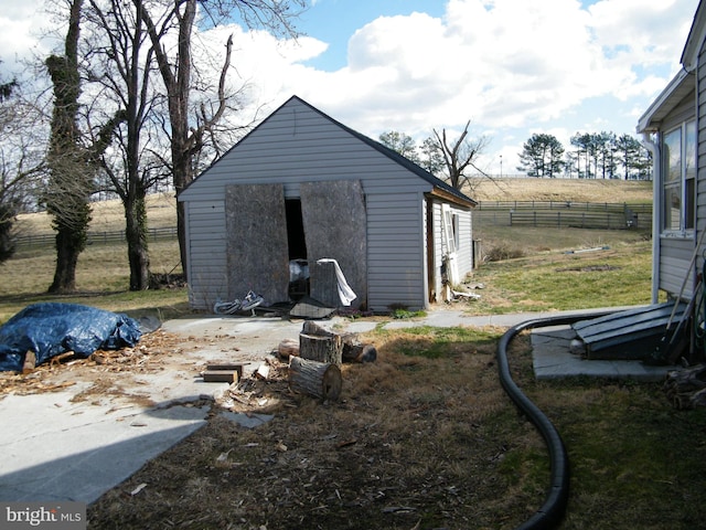 view of outdoor structure with a rural view