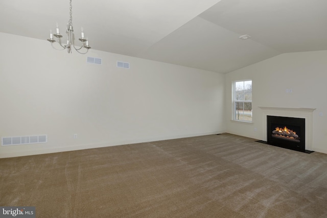 unfurnished living room with an inviting chandelier, light carpet, and vaulted ceiling