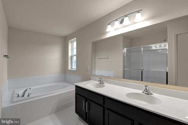 bathroom with tiled bath, tile floors, and dual vanity