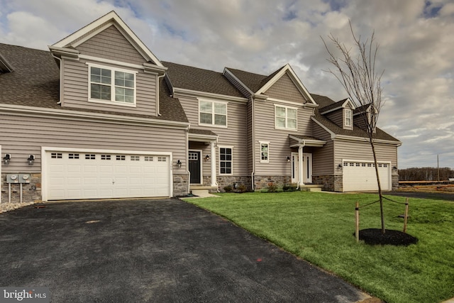 view of front of home with a front lawn and a garage