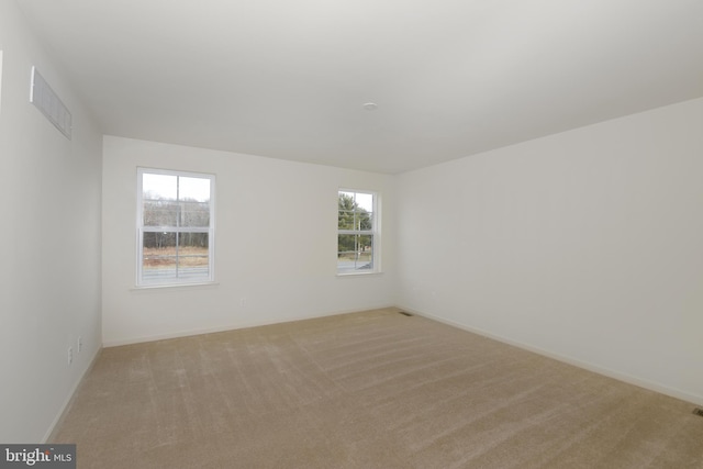 unfurnished room with light colored carpet