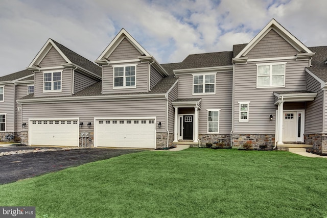 view of front of house featuring a front yard and a garage