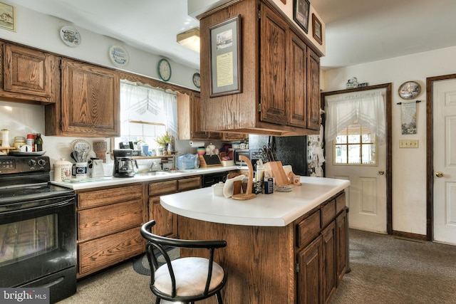 kitchen featuring a kitchen breakfast bar, sink, dark carpet, and black electric range oven