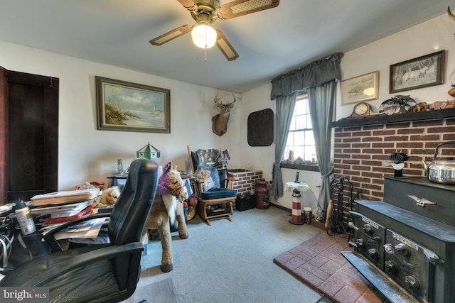 carpeted home office featuring ceiling fan