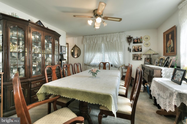 carpeted dining room featuring ceiling fan