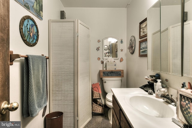 bathroom with large vanity and toilet