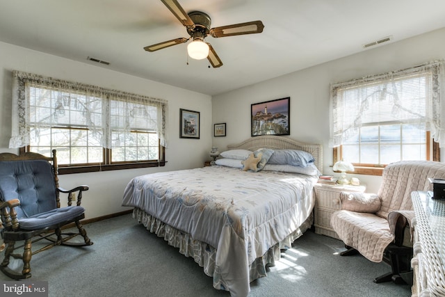 carpeted bedroom featuring ceiling fan and multiple windows