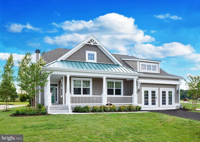 view of front of property with a porch and a front lawn