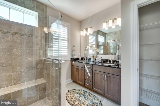 bathroom featuring vanity, tile patterned floors, and a shower with door